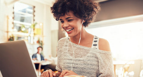 Image,Of,Happy,Woman,Using,Laptop,While,Sitting,At,Cafe.